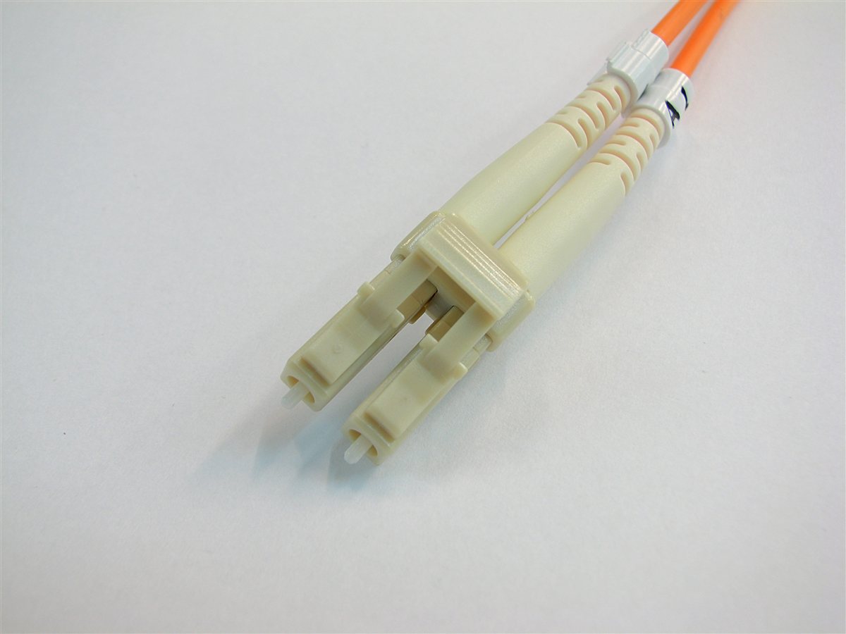 Photograph of a duplex LC optical fiber connector showing the two ferrules