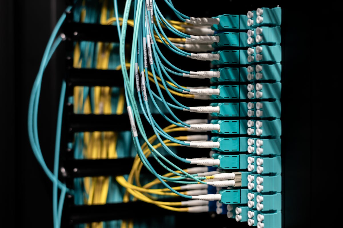 A patch panel with multicolor cables in a communications room