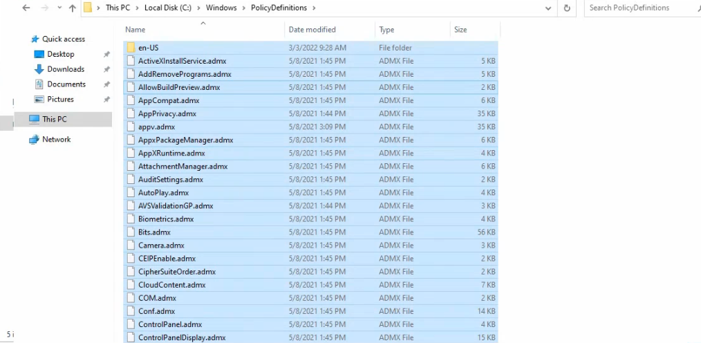 File Explorer at C colon backslash Windows backslash PolicyDefinitions showing the local source set with hundreds of ADMX files plus the en-US sub-folder selected and copied to clipboard
