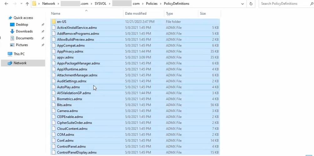 File Explorer pasting the local PolicyDefinitions contents into the new SYSVOL central-store path with the same ADMX files and en-US sub-folder now visible at the central location