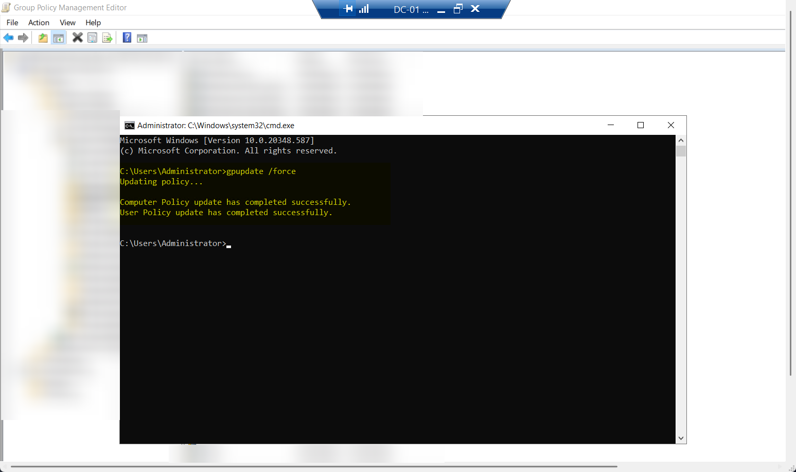 Command Prompt window on a Domain Controller after running gpupdate /force showing the User policy and Computer policy update successfully completed messages, confirming the new GPO has been pulled and applied to this DC