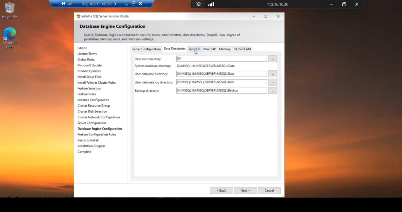 Same Database Engine Configuration step on the Data Directories tab showing the Data Root directory automatically pointing at the cluster disk D:\\... confirming SQL data files will live on shared storage