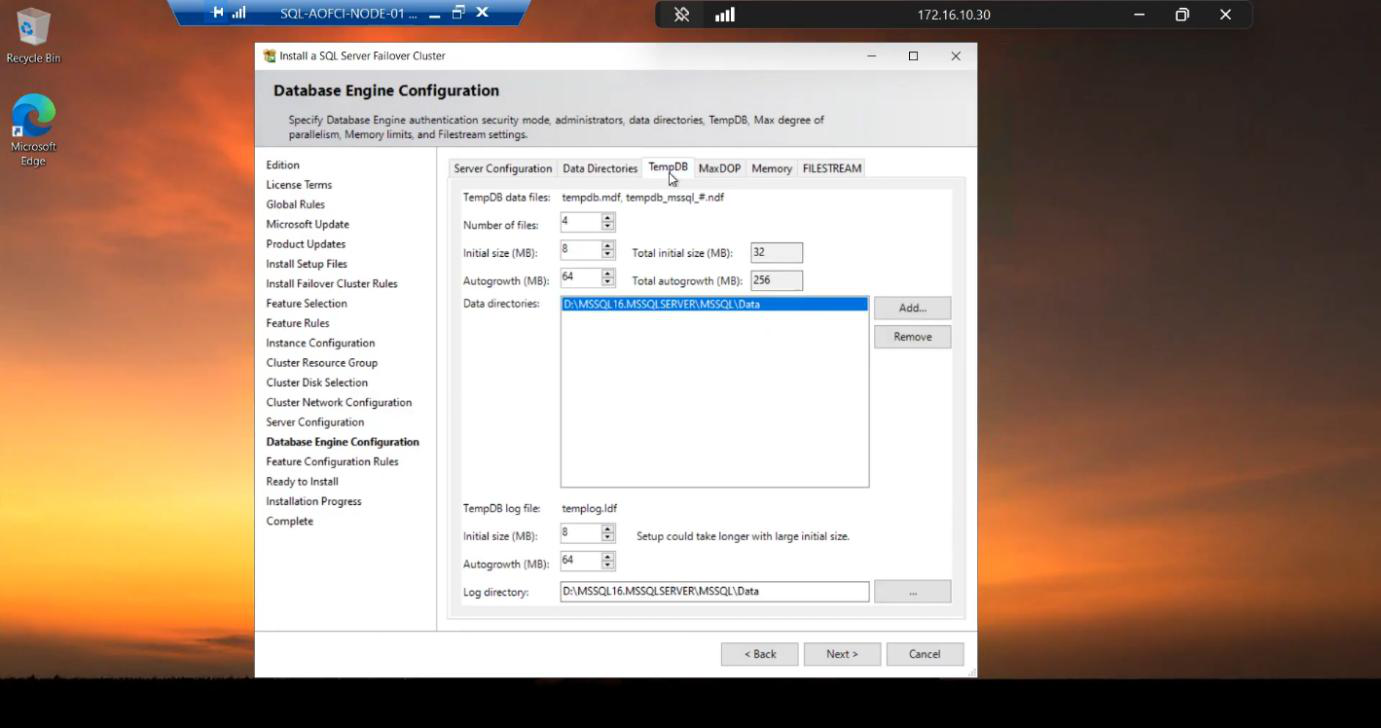 Same Database Engine Configuration step on the TempDB tab also defaulting to the cluster disk path, ensuring tempdb files are on shared storage and visible after a failover