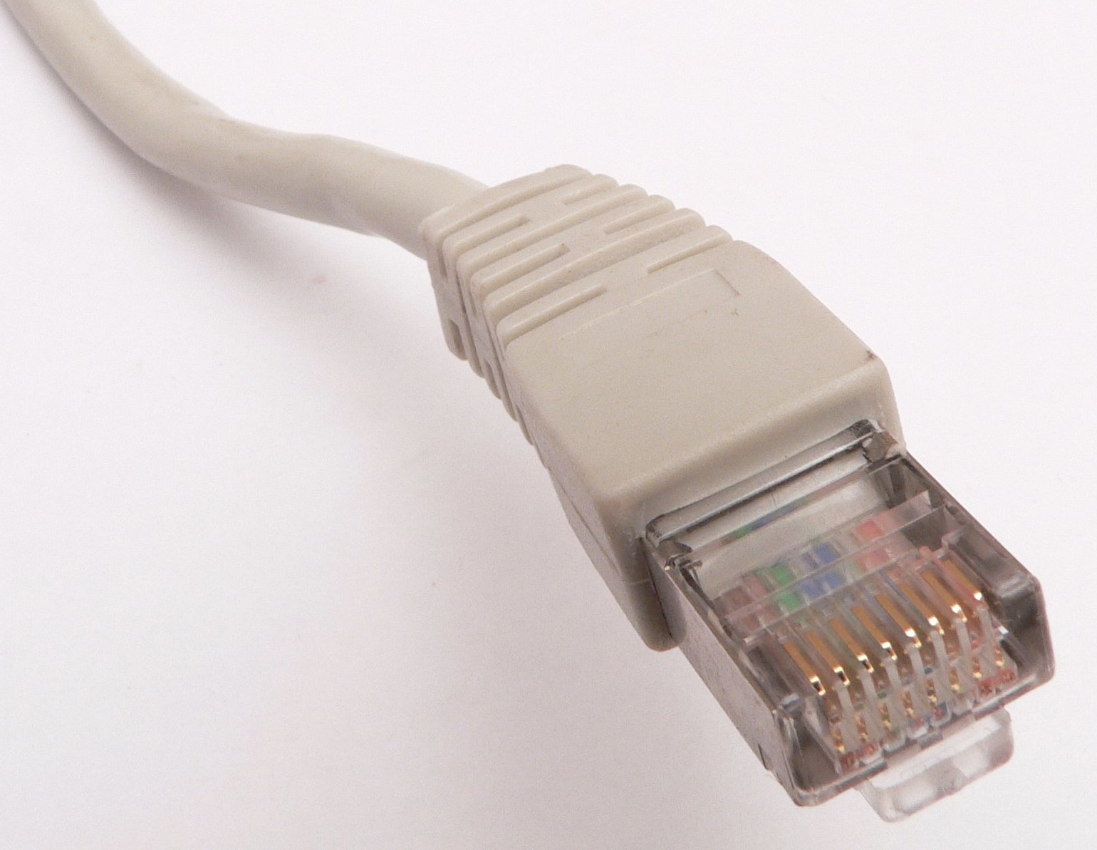 Close-up photograph of an RJ45 ethernet connector showing the eight conductor pins